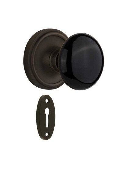 Classic Rosette Mortise-Lock Set with Black Porcelain Knobs in Oil-Rubbed Bronze.